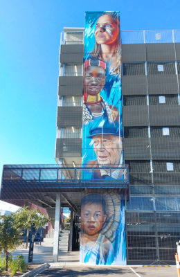 Four faces spray painted mural on Brimbank Multi-deck car park