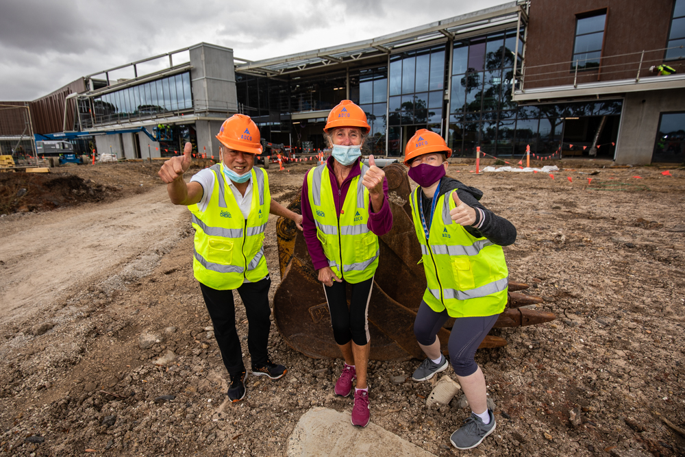 Brimbank Leisure Centre members give a thumbs up to the new Brimbank Aquatic and Wellness Centre currently under construction